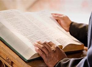 Close up image of someone reading a bible.